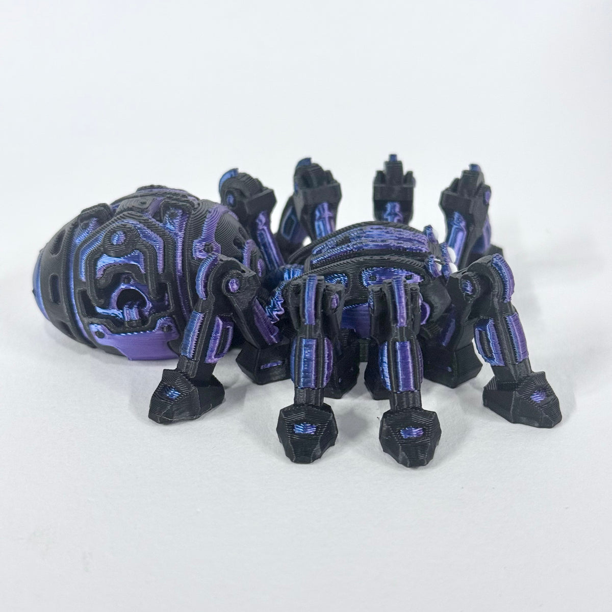 Cyber Spider shown from a rear three-quarter angle, highlighting its articulated legs and blue and purple details on the black body.