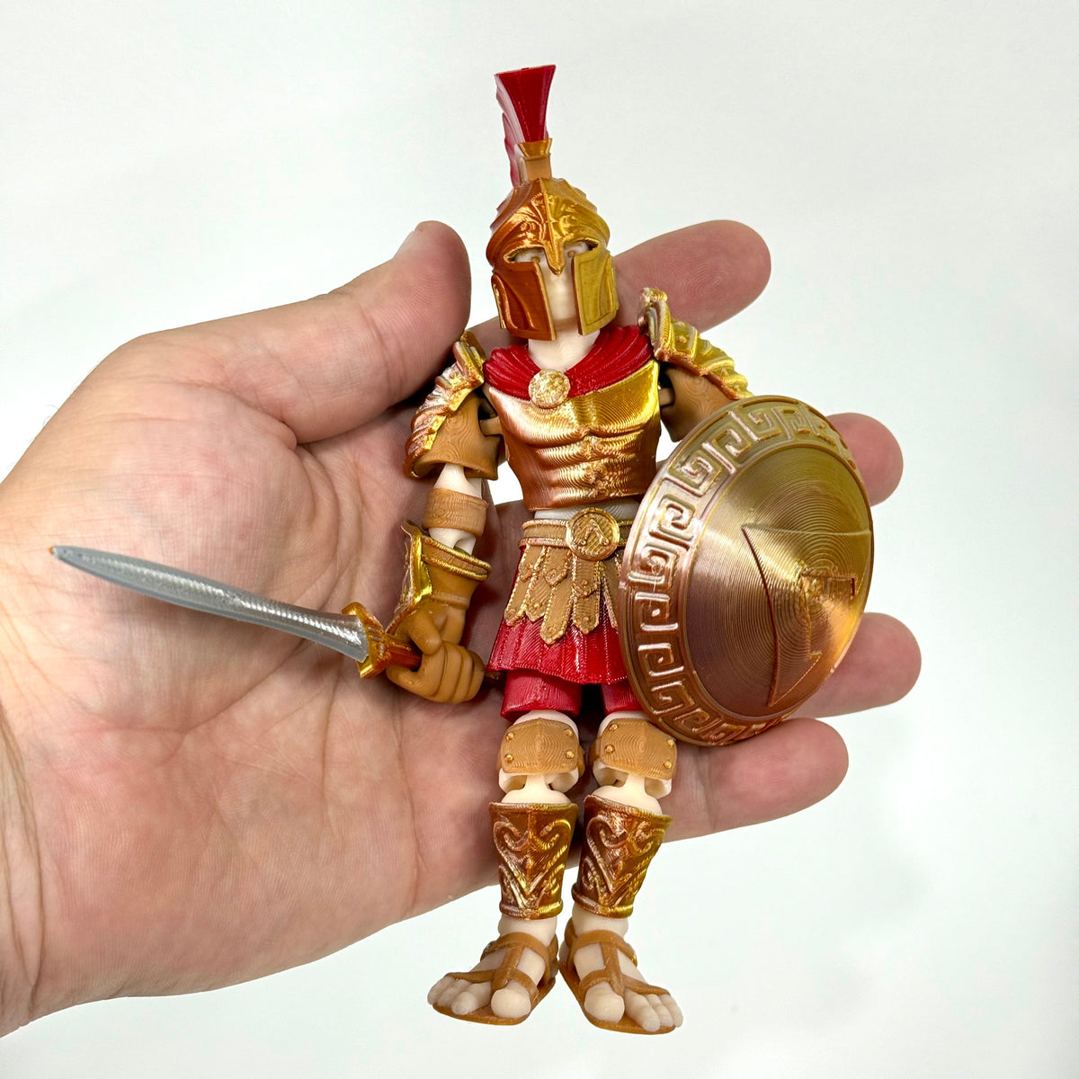Spartan Champion 3D printed figure shown in hand for scale – Iubi Design 3D